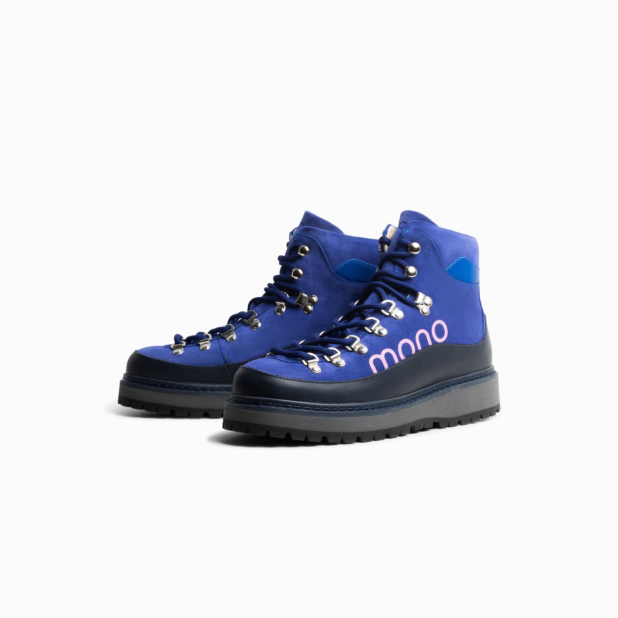 Pair of blue and black hiking boots with 'mono' branding on a white background