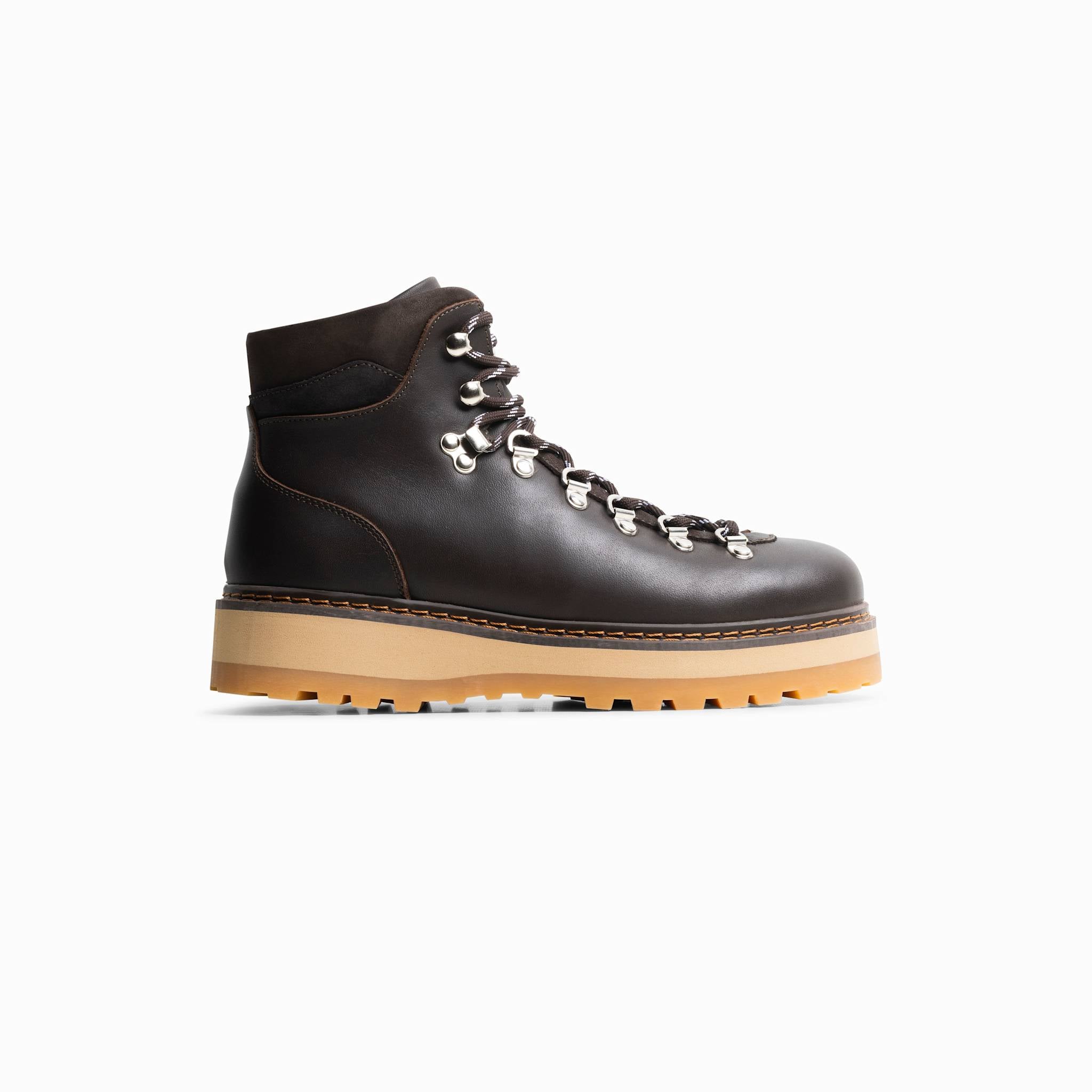 Dark brown hiking boot with a tan sole on a white background