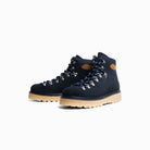 Pair of navy blue hiking boots with tan soles on a white background