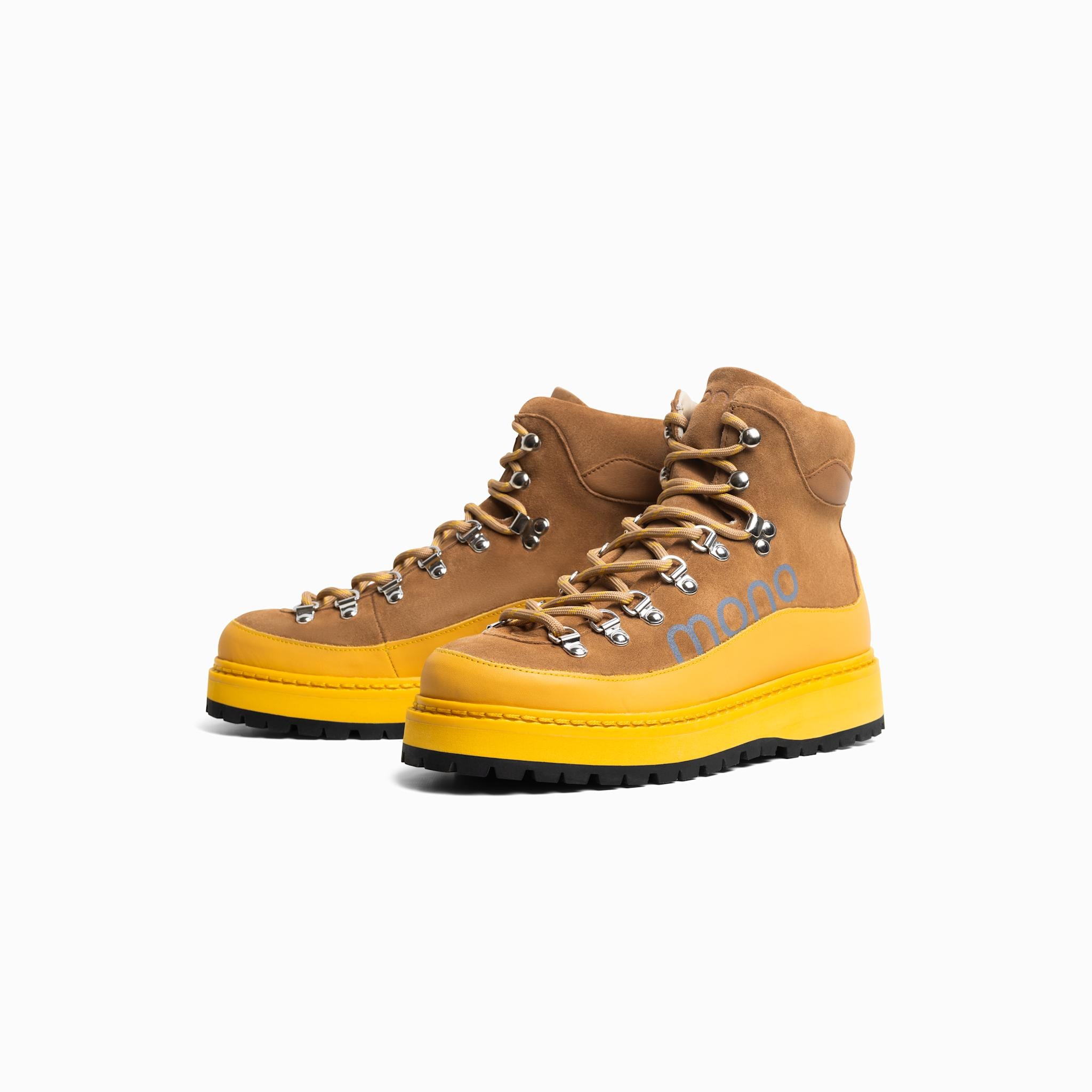Pair of brown and yellow hiking boots on a white background