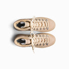 Pair of beige boots with white laces on a white background
