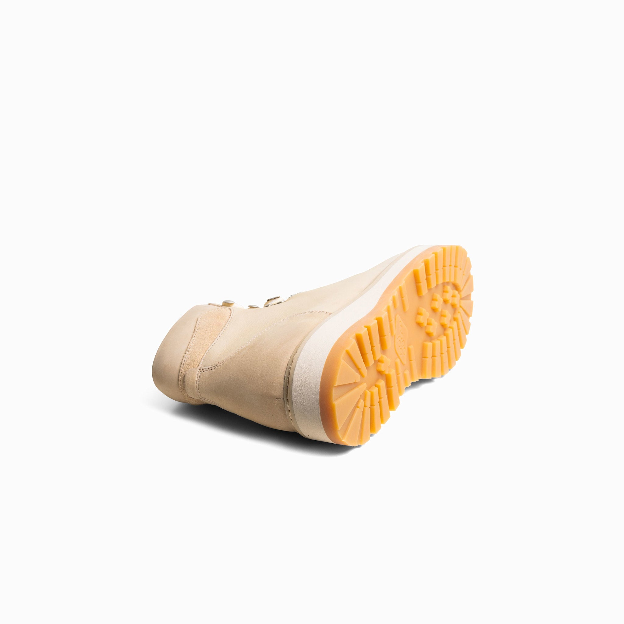 Beige boot with a yellow sole on a white background