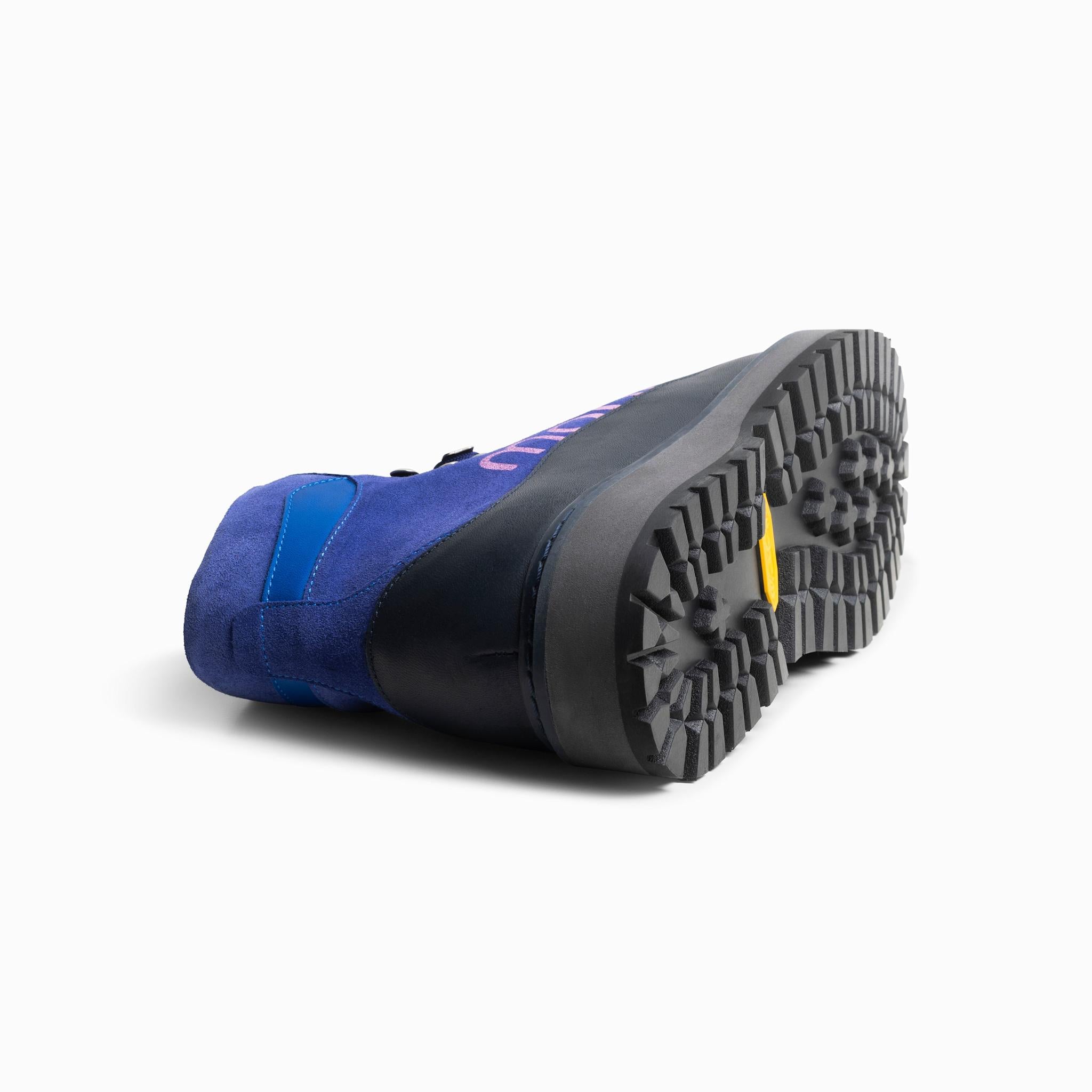 Blue and black boot sole on a white background. Vibram sole