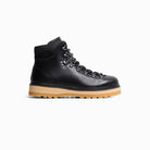 Black hiking boot with tan sole on a white background