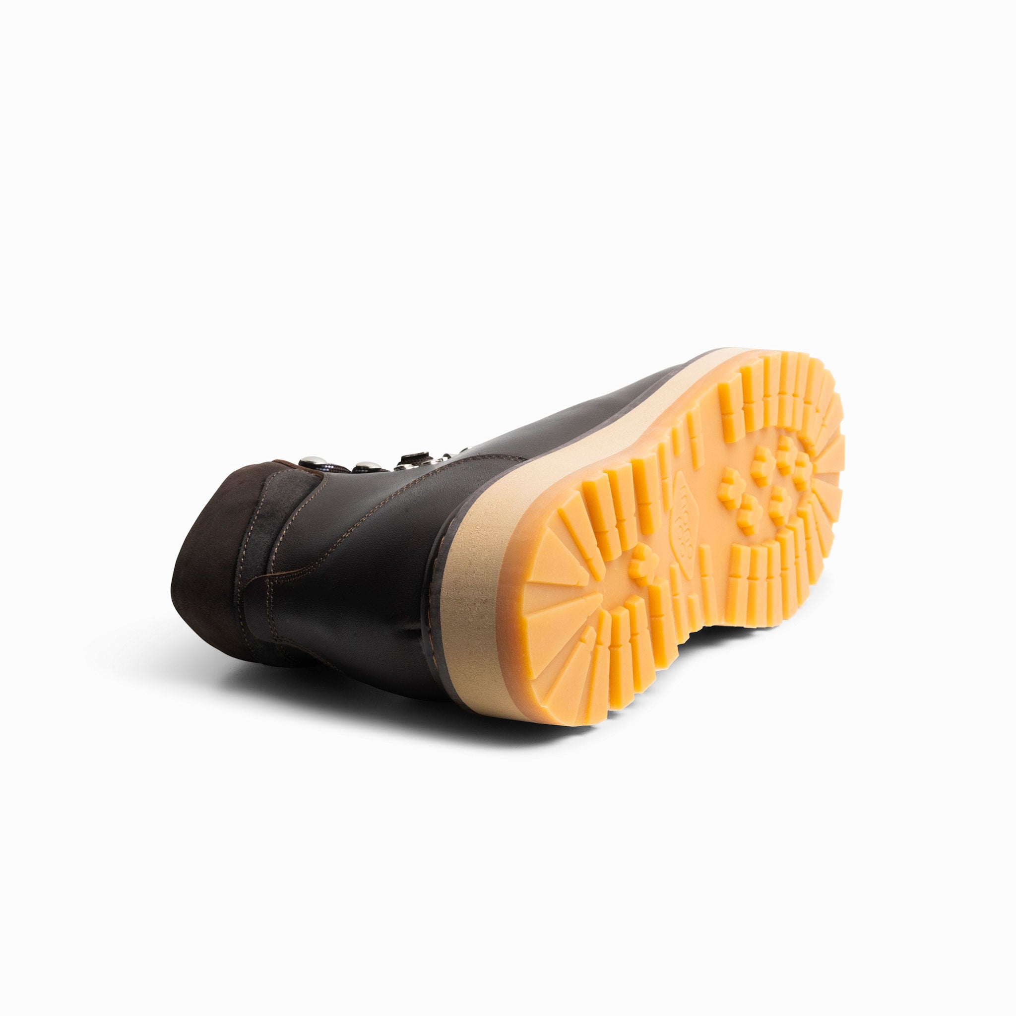 Black boot with orange sole on a white background