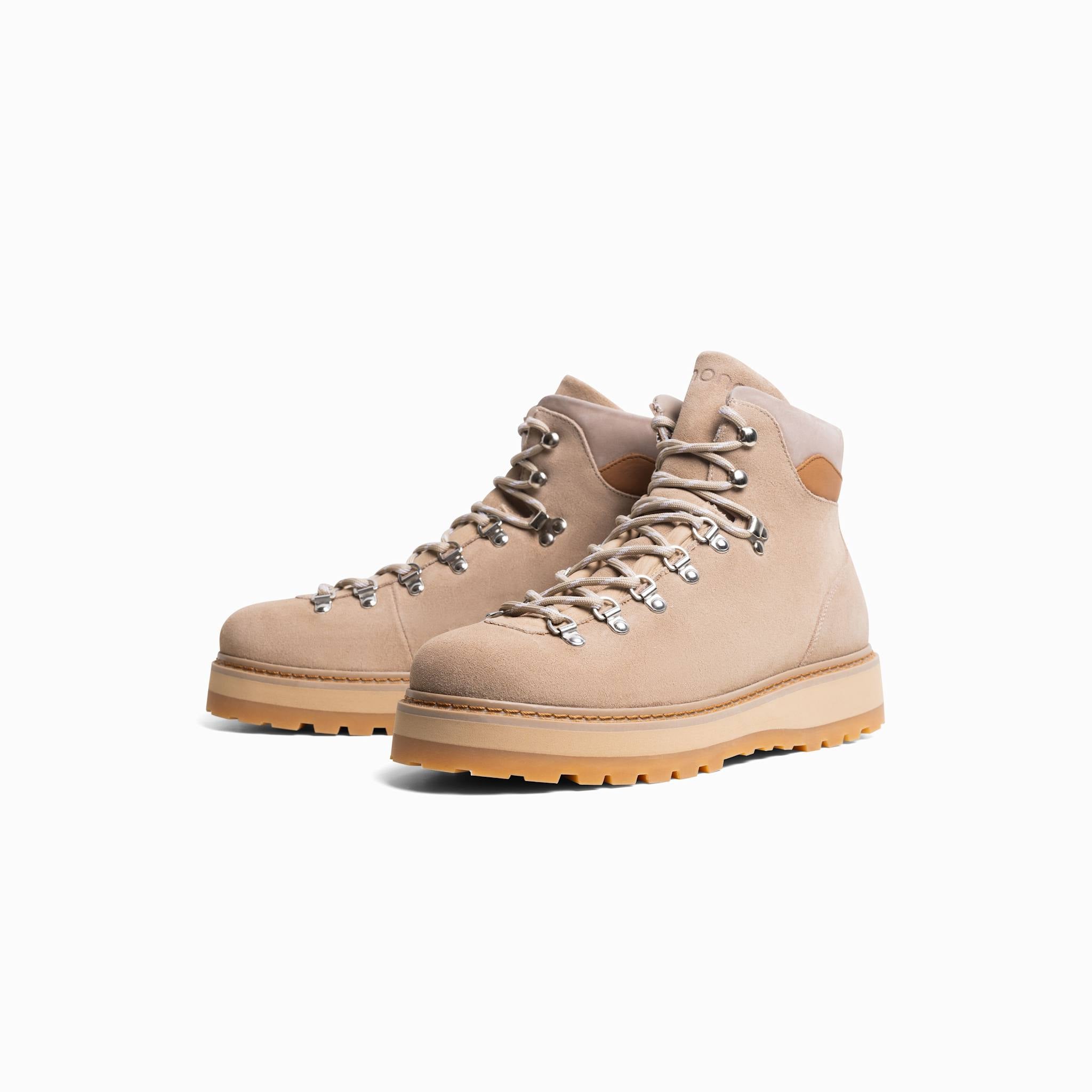 Pair of beige hiking boots on a white background