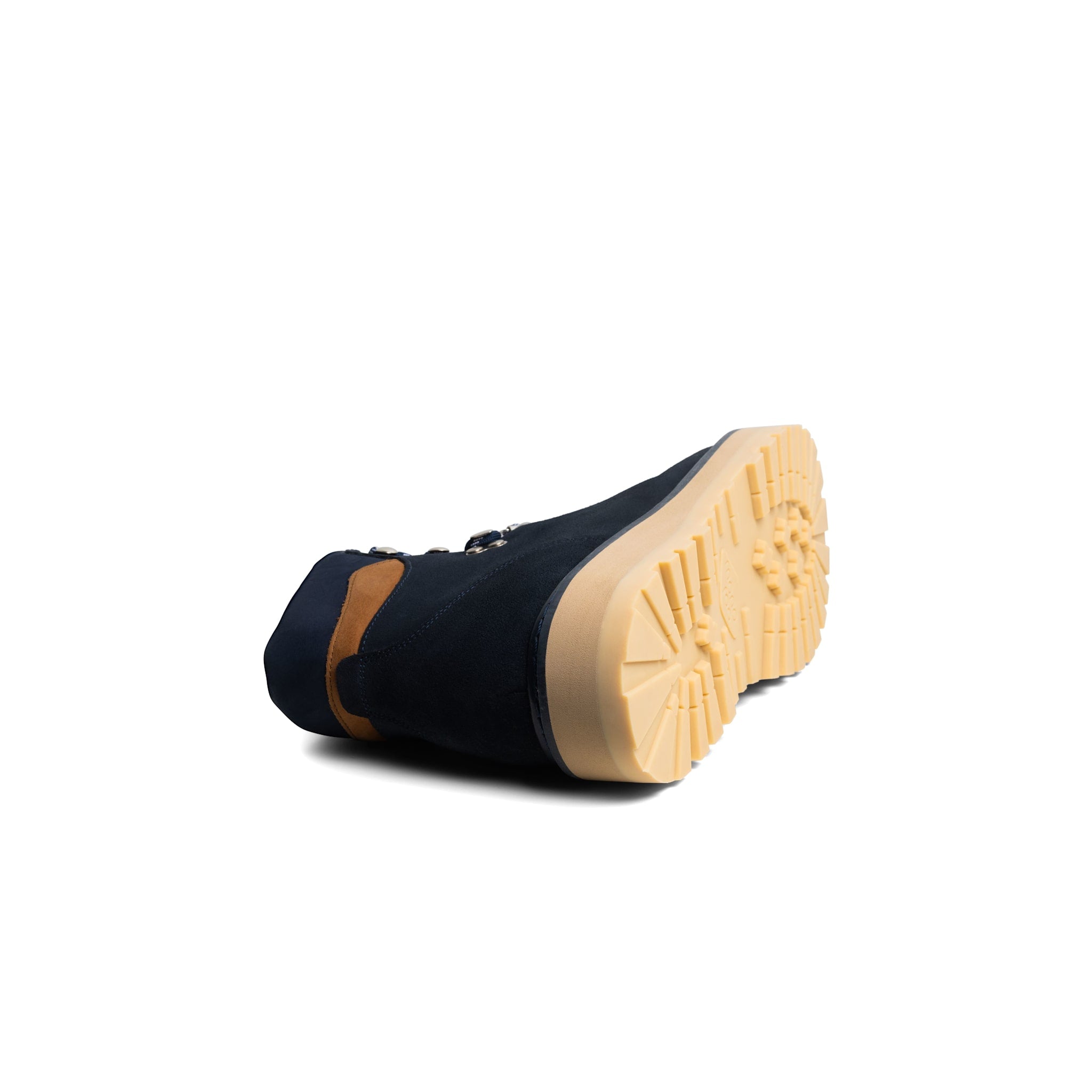 Navy boot with tan sole on a white background